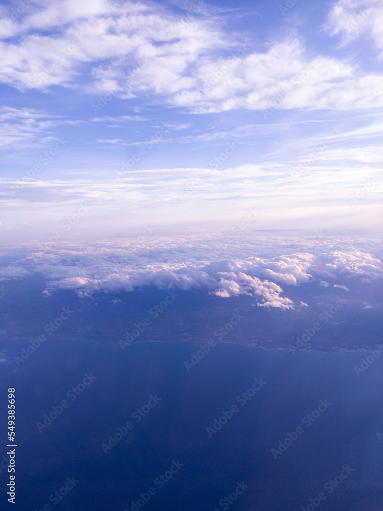 View from airplane to sky, clouds and land