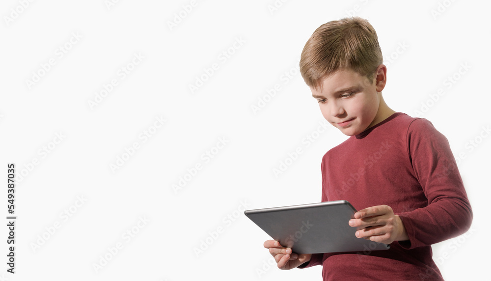 Banner Little boy boy playing tablet. White background. Red shirt. Banner Little boy boy playing tablet. White background. Red shirt.