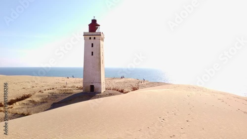 Aerial flight around the iconic lighthouse Rubjerg Knude Fyr at the danish coast