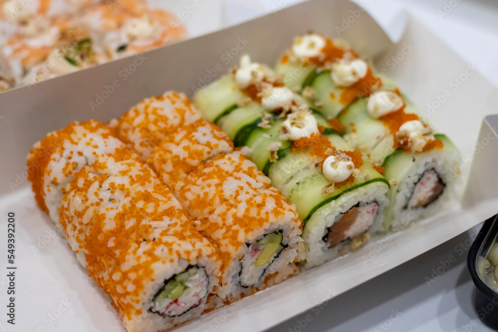 Rolls with flying fish roe, crab and cucumber. Japanese food from home delivery. Rolls with flying fish roe, crab and cucumber. Japanese food from home delivery.