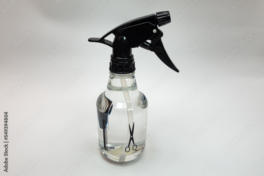spray bottle containing water on a white background