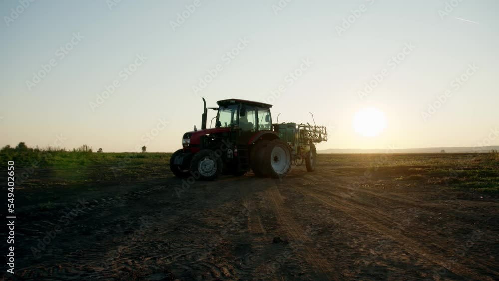 preparation process of spraying with chemicals and pesticides fields with potatoes. Growing potatoes in fields and cultivating vegetables. tractor pulls barrel with irrigation system behind it. preparation process of spraying with chemicals and pesticides fields with potatoes. Growing potatoes in fields and cultivating vegetables. tractor pulls barrel with irrigation system behind it.
