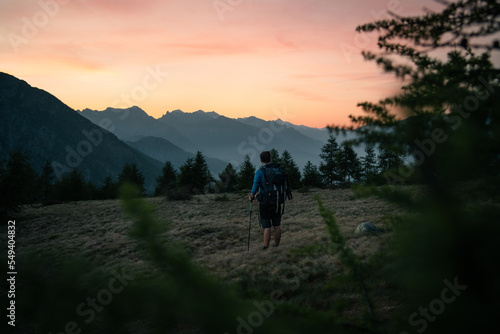 A hiker is exploring the area of Mount Berlinghera after sunset, with a colorful sky in the background © Stefano Dosselli