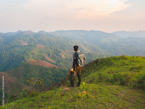 Men backpacker are happy and enjoy with sunrise after successful hiking. © TongTa