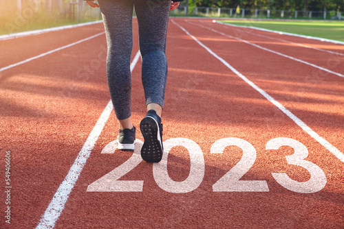 Starting to the new year 2023. Woman a runner waiting to start the new year 2023.Planning, opportunity, challenge, and business strategy. Goals, plans, and Adopt for Success in 2023 for new life.