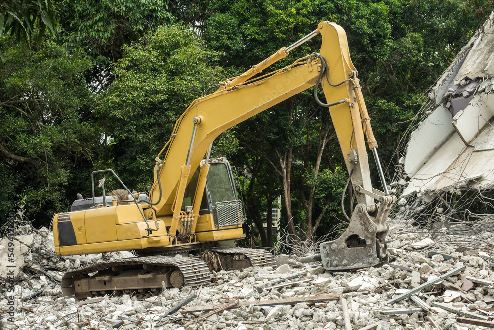 Excavator with hydraulic hammer on road construction works Excavator with hydraulic hammer on road construction works