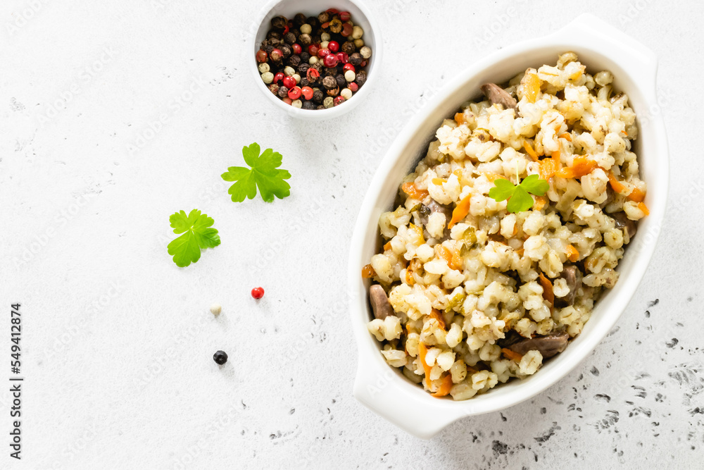 Barley risotto with vegetables and chicken. Top view, copy space, flat lay. Barley risotto with vegetables and chicken. Top view, copy space, flat lay.