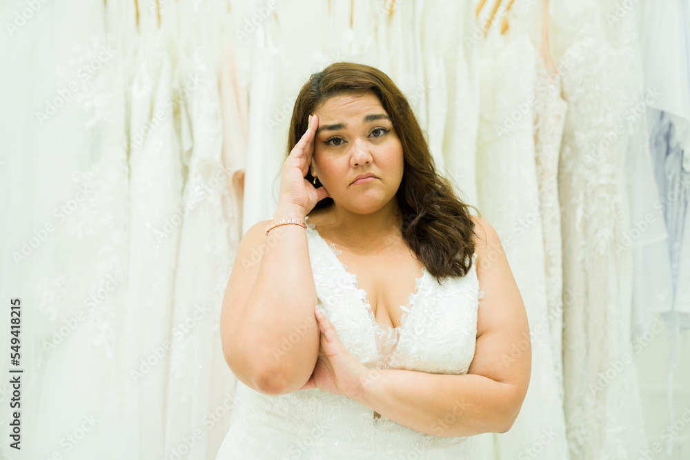 Fototapeta premium Upset stressed woman buying her wedding gown