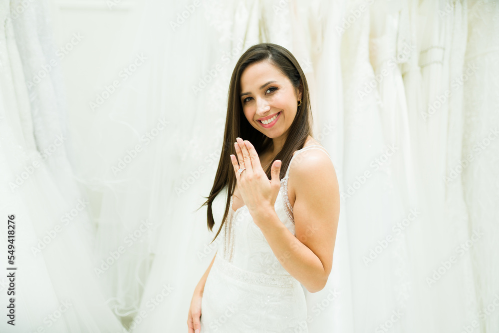 Cheerful woman with her engagement ring at the bridal store Cheerful woman with her engagement ring at the bridal store