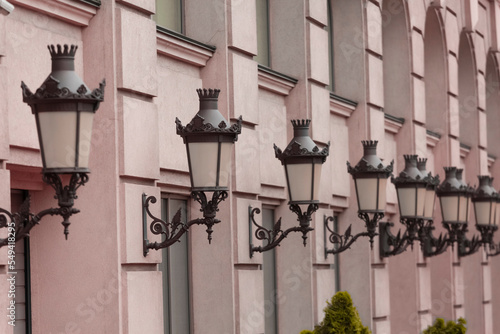 Vintage lanterns on old houses. Ancient houses in a European city.
