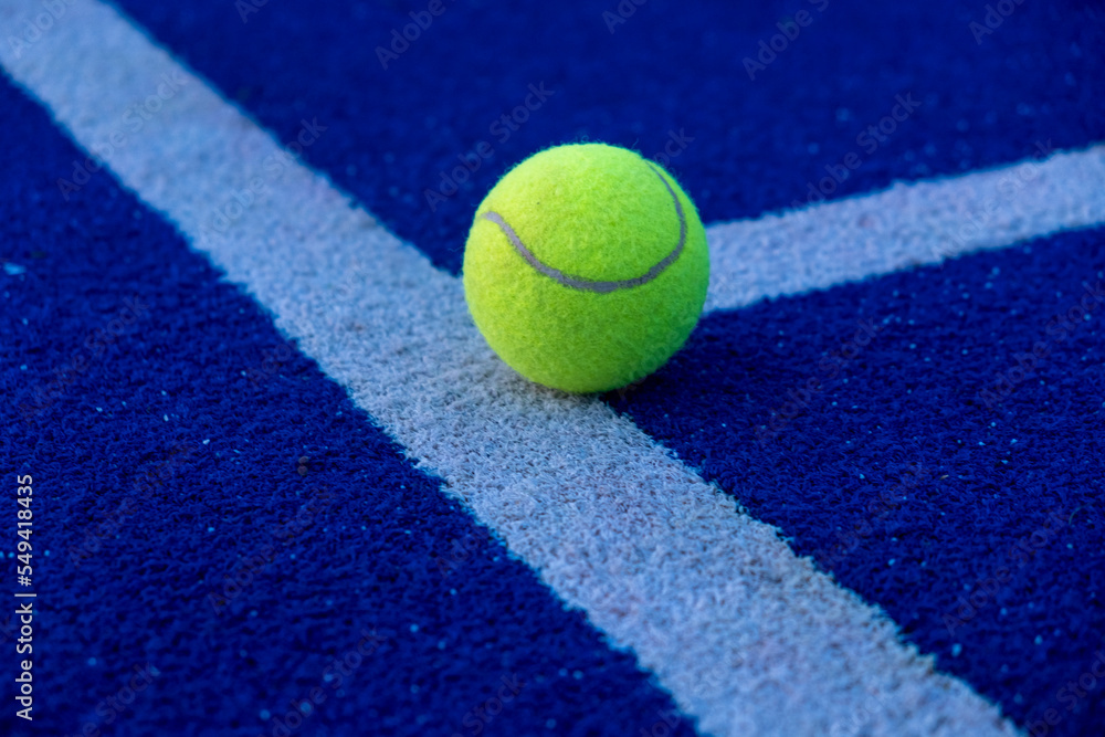 selective focus, a ball on an artificial grass paddle tennis court