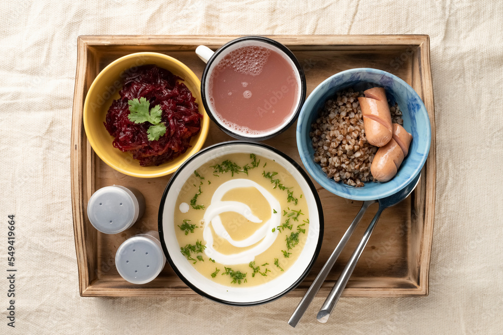 Set lunch in bowls in a wooden serving box. Food and catering concept. Open container for food Set lunch in bowls in a wooden serving box. Food and catering concept. Open container for food