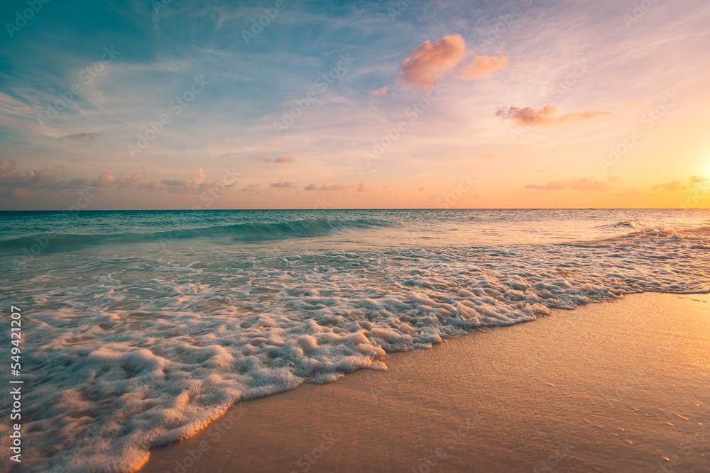 Summer seascape beautiful waves, sunset sea sand sky. Amazing Mediterranean tropical nature background. Beautiful bright sea bay waves splashing on sandy shore in sunset light. Tranquil landscape