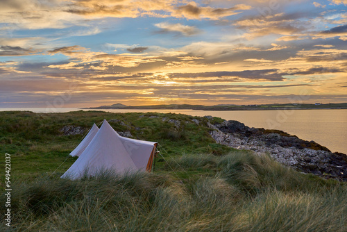 Tents at sunset with dramatic cloud sky  at Clifton beach in county Galway  western part of the Republic of Ireland