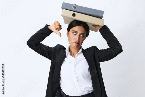 Business woman with a folder of documents in her hands in a black business suit and glasses shows signals gestures and emotions on a white background, work freelancer online training