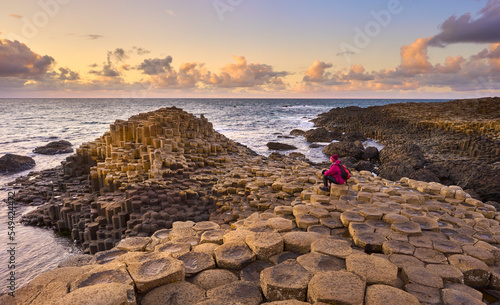 Irish coastline with Volcanic hexagonal basalt columns of Giant`s Causeway at sunset in Northern Ireland photo