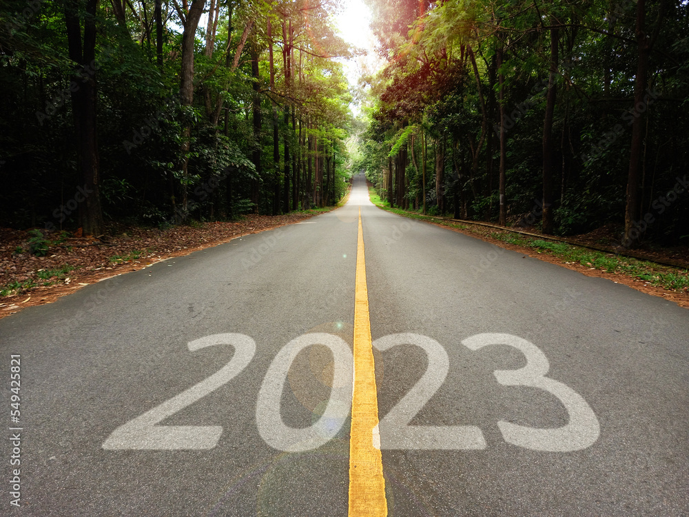 Obraz premium welcome 2023 new year, long road with 2023 in the asphalt