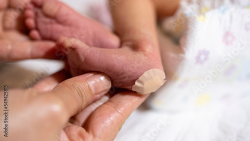 Newborn heel prick test and lood puncture, Taking a Heel Blood Sample From Newborn Baby