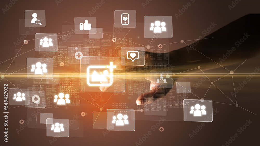 Hand pressing social media multimedia application screen with media icons on futuristic concept Hand pressing social media multimedia application screen with media icons on futuristic concept