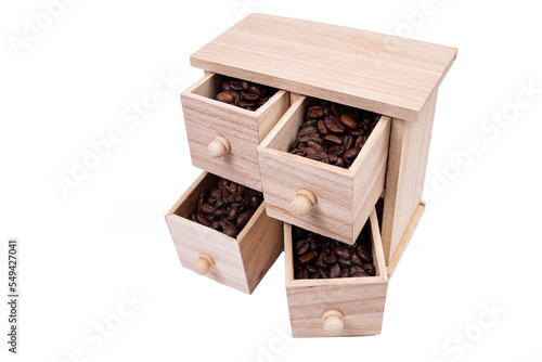 Wooden box with cells filled with coffee beans. Coffee beans scattered side by side Isolated on white background © Anton