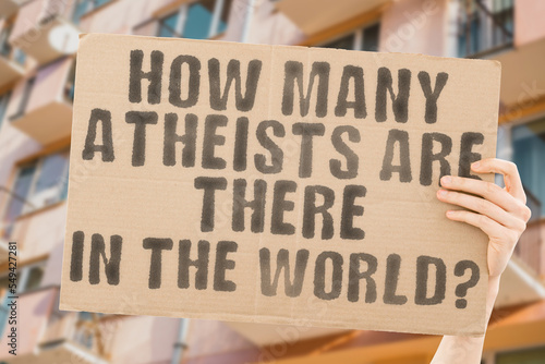 Wallpaper Mural The question " How many atheists are there in the world? " is on a banner in men's hands with blurred background. Spirituality. Science. Nonbeliever. Agnostic. Buddhism. Agnosticism. Asceticism Torontodigital.ca