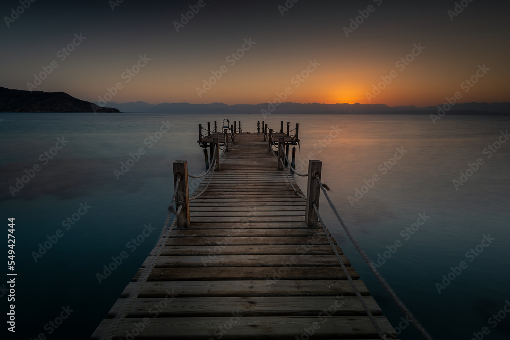 Wooden pier and sunrise over the beautiful Akaba Bay Egypt