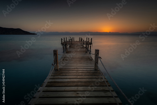 Fototapeta Naklejka Na Ścianę i Meble -  Wooden pier and sunrise over the beautiful Akaba Bay Egypt