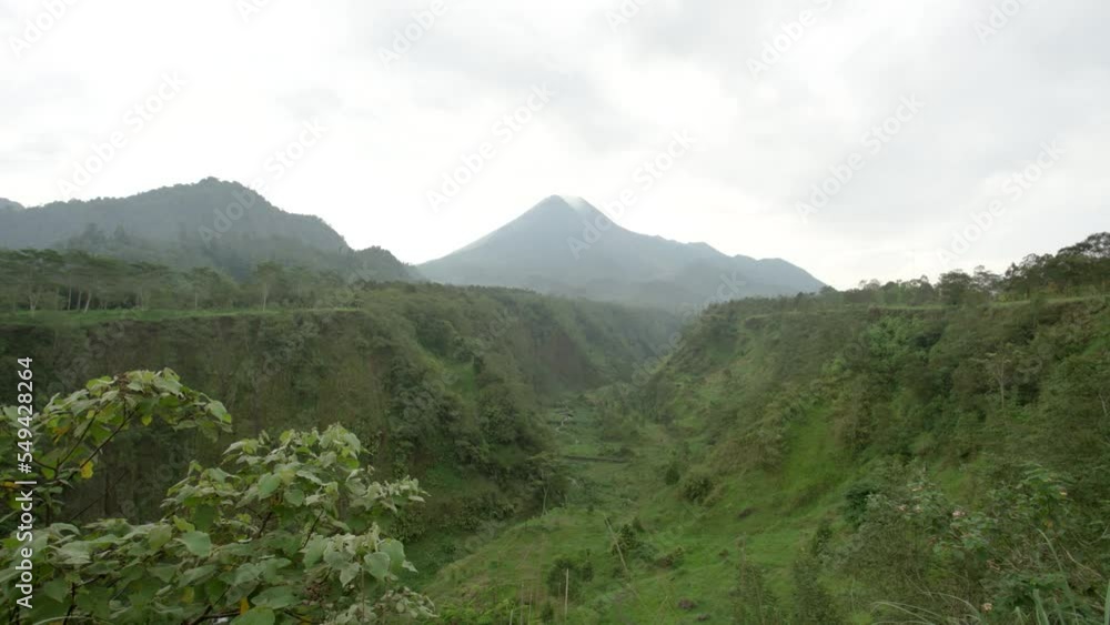 time lapse of moving clouds and Merapi volcano mountain in Yogyakarta, Indonesia emits smoke time lapse of moving clouds and Merapi volcano mountain in Yogyakarta, Indonesia emits smoke
