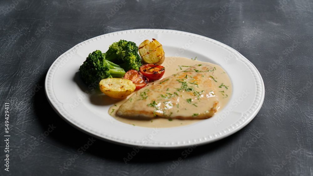 fish dish with sauce on black background fish dish with sauce on black background