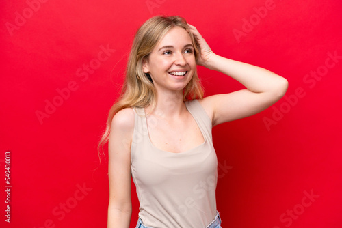 Young English woman isolated on red background smiling a lot