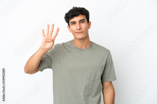 Young Argentinian man isolated on white background happy and counting four with fingers © luismolinero