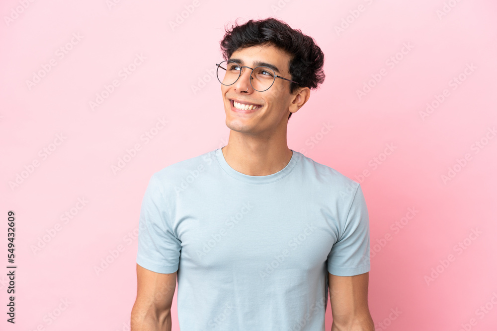 Young Argentinian man isolated on pink background With glasses with happy expression Young Argentinian man isolated on pink background With glasses with happy expression