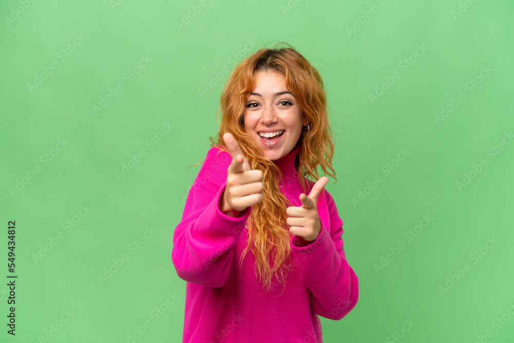Young caucasian woman isolated on green screen chroma key background surprised and pointing front Young caucasian woman isolated on green screen chroma key background surprised and pointing front
