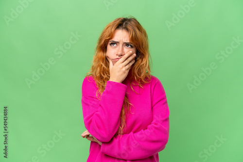 Young caucasian woman isolated on green screen chroma key background having doubts and with confuse face expression
