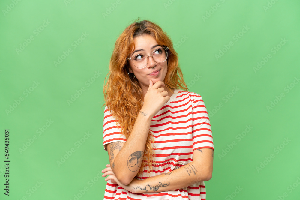 Young caucasian woman isolated on green screen chroma key background and looking up Young caucasian woman isolated on green screen chroma key background and looking up