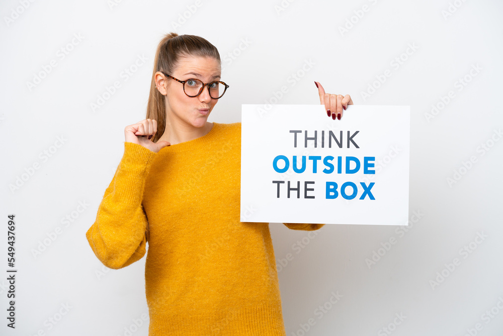 Young caucasian woman isolated on white background holding a placard with text Think Outside The Box with proud gesture Young caucasian woman isolated on white background holding a placard with text Think Outside The Box with proud gesture