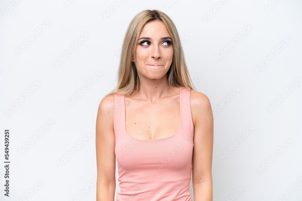 Pretty blonde woman isolated on white background having doubts while looking up Pretty blonde woman isolated on white background having doubts while looking up