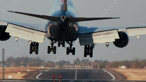 Passenger aircraft landing Close up. Passenger airplane landing towards the runway during sunset. Wheels touchdown close up shot. 4k photo