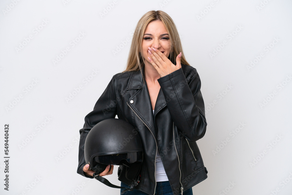 Pretty blonde woman with a motorcycle helmet isolated on white background happy and smiling covering mouth with hand Pretty blonde woman with a motorcycle helmet isolated on white background happy and smiling covering mouth with hand