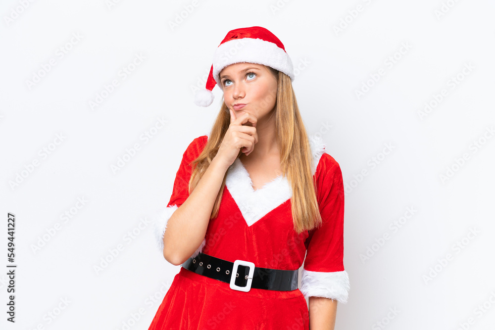 Young caucasian woman dressed as mama noel isolated on white background having doubts Young caucasian woman dressed as mama noel isolated on white background having doubts