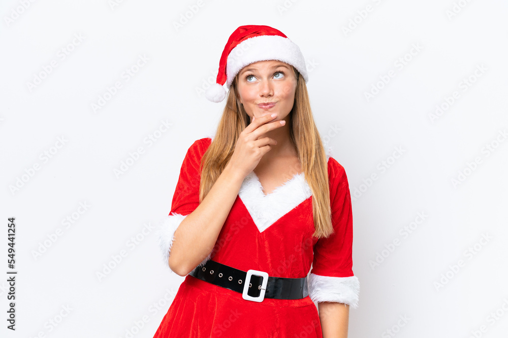 Young caucasian woman dressed as mama noel isolated on white background looking up while smiling Young caucasian woman dressed as mama noel isolated on white background looking up while smiling