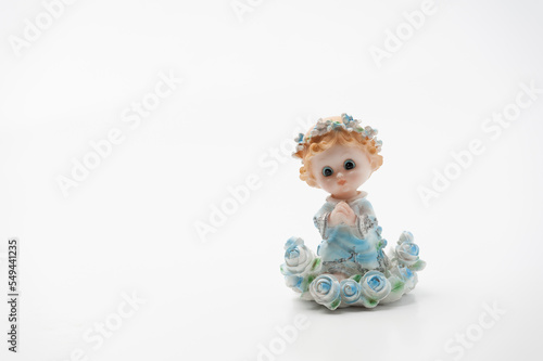figurine of a cute angel during prayer on a white background