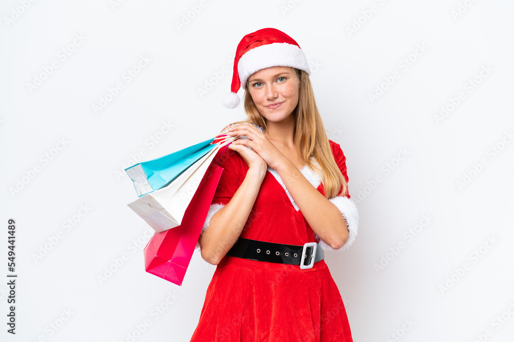 Young caucasian woman dressed as mama noel isolated on white background holding shopping bags Young caucasian woman dressed as mama noel isolated on white background holding shopping bags