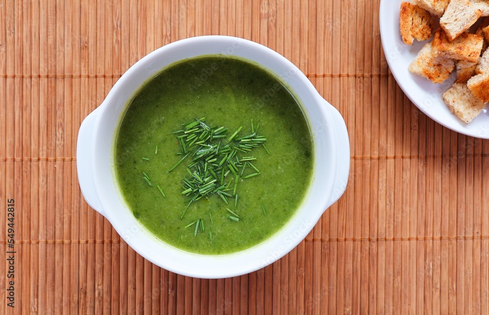 Chervil soup and bread croutons. Green vegetable soup. Top view. Chervil soup and bread croutons. Green vegetable soup. Top view.