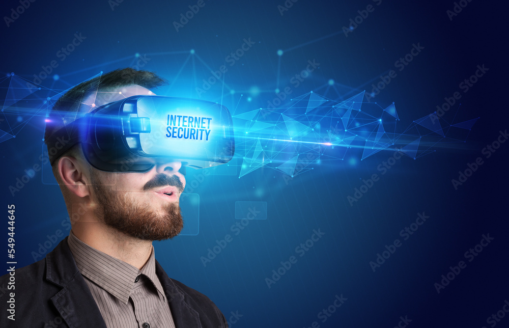 Businessman looking through Virtual Reality glasses, virtual security concept Businessman looking through Virtual Reality glasses, virtual security concept