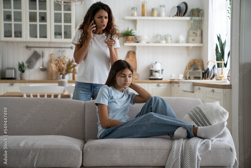Overbearing parent mother talking with school teacher by phone, getting