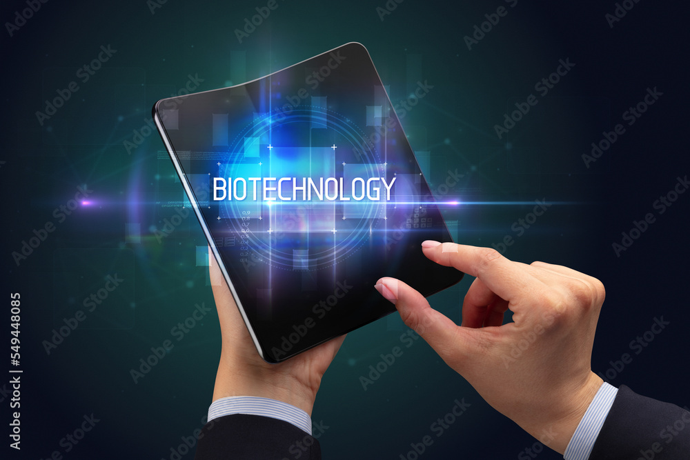 Businessman holding a foldable smartphone Businessman holding a foldable smartphone
