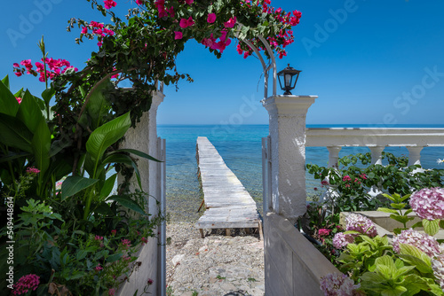 Traditional greek view with a white wooden pier in the background
