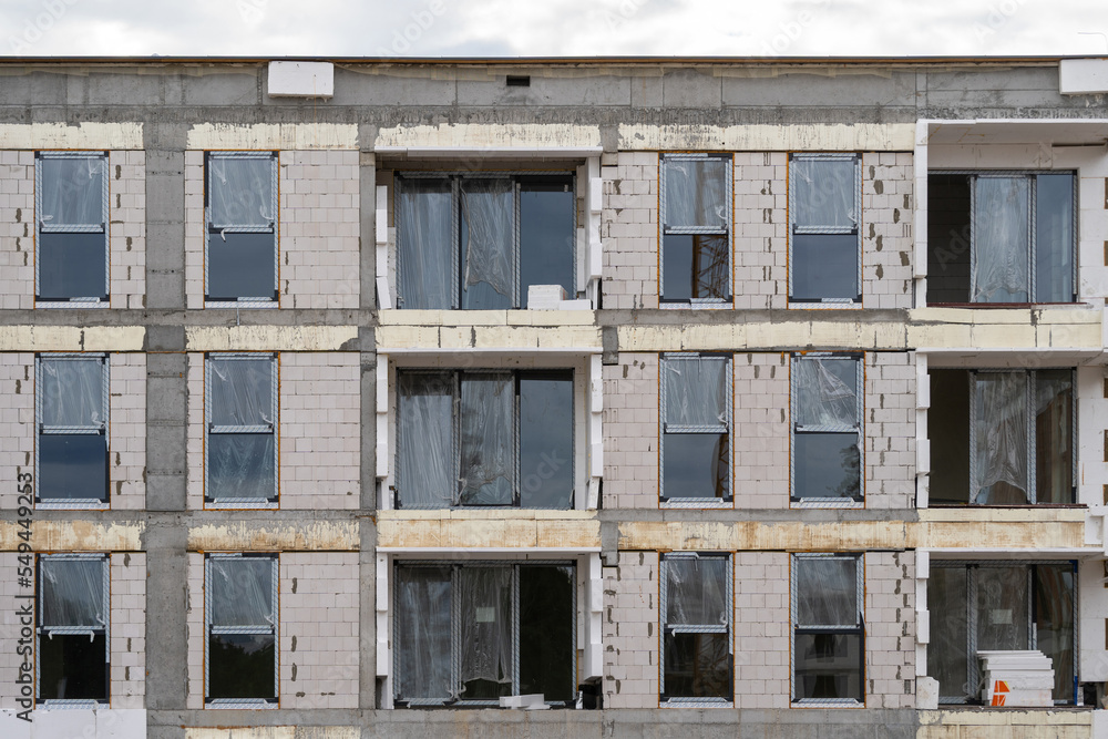 Facade of new panel block house with plastic windows Facade of new panel block house with plastic windows