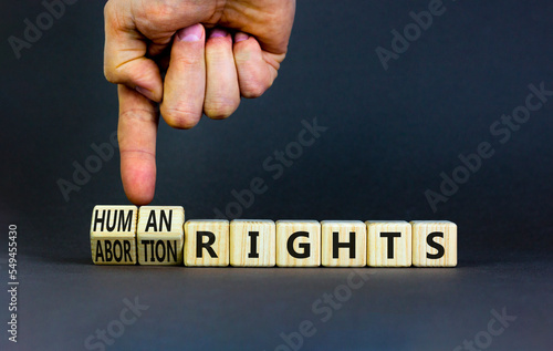 Abortion rights symbol. Concept words Abortion rights are human rights on wooden cubes. Businessman hand. Beautiful grey table grey background. Business medical abortion rights concept. Copy space.
